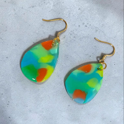 A matching pair of handmade recycled plastic drop dangle earrings in translucent clear blue, designed in Australia.