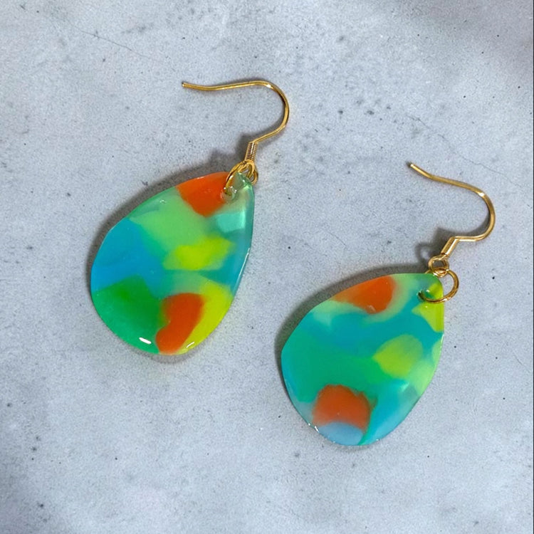 A matching pair of handmade recycled plastic drop dangle earrings in translucent clear blue, designed in Australia.