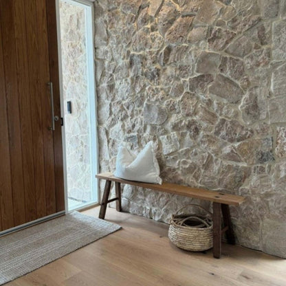 Zebra Home Franklin natural tone recycled plastic hallway runner rug styled next to a stone feature wall.