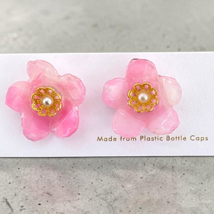 A pair of handmade upcycled plastic Sakura stud earrings in a pink cherry blossom floral design, handcrafted in Australia.
