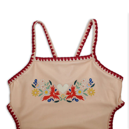 Close-up detail of the premium embroidered fire bird chest print and stitched scallop borders on the kids bather.