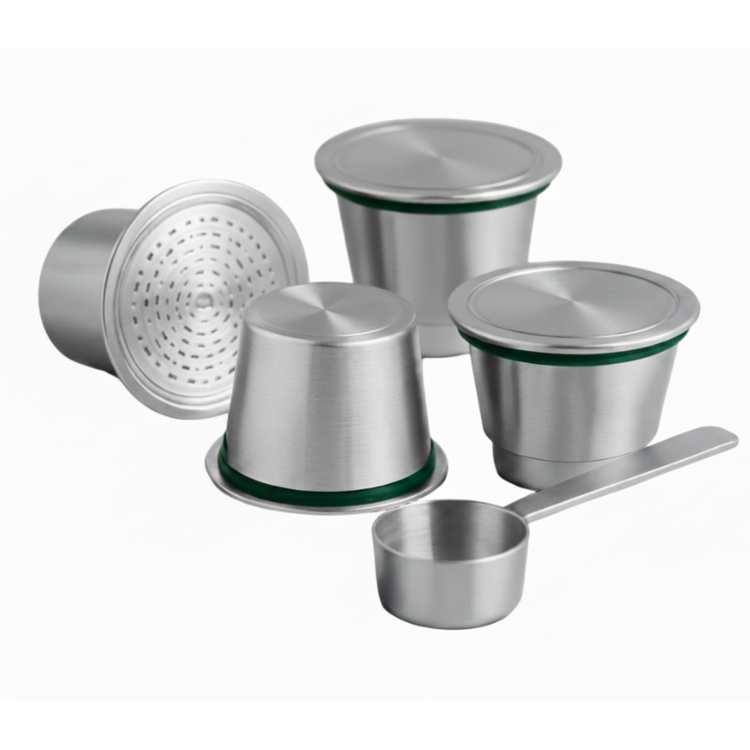 Four eco-friendly reusable stainless steel nespresso capsules arranged with a scoop on a white background.