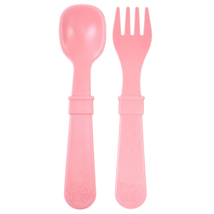 Single matching Re Play recycled plastic toddler fork and spoon cutlery set on a clean white background, available in Australia in Baby Pink