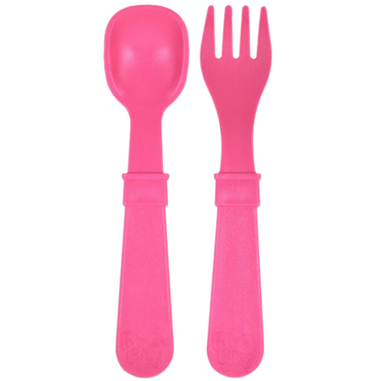 Single matching Re Play recycled plastic toddler fork and spoon cutlery set on a clean white background, available in Australia in bright pink