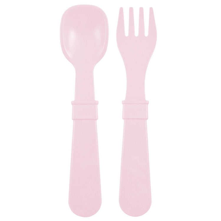 Single matching Re Play recycled plastic toddler fork and spoon cutlery set on a clean white background, available in Australia in Ice Pink