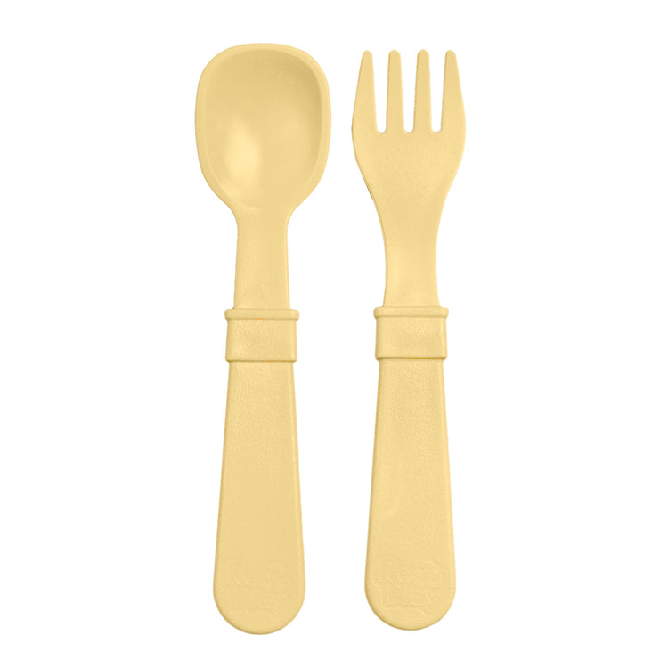 Single matching Re Play recycled plastic toddler fork and spoon cutlery set on a clean white background, available in Australia in Lemon Drop