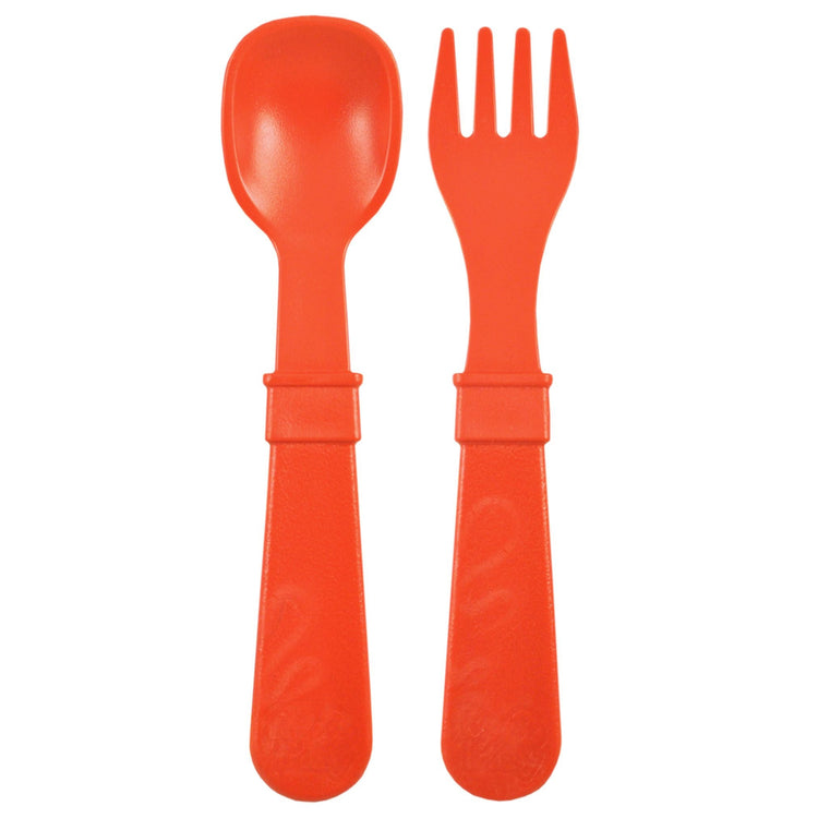 Single matching Re Play recycled plastic toddler fork and spoon cutlery set on a clean white background, available in Australia in Red