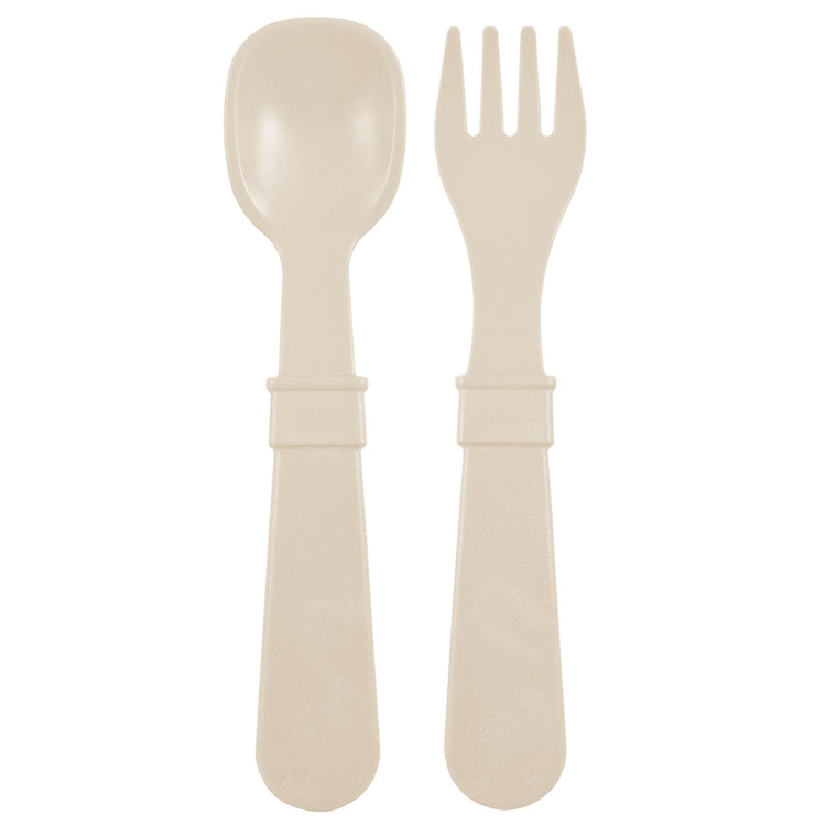 Single matching Re Play recycled plastic toddler fork and spoon cutlery set on a clean white background, available in Australia in Sand