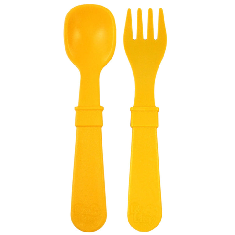 Single matching Re Play recycled plastic toddler fork and spoon cutlery set on a clean white background, available in Australia in Sunny Yellow