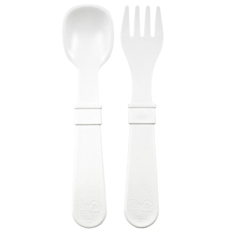 Single matching Re Play recycled plastic toddler fork and spoon cutlery set on a clean white background, available in Australia in White