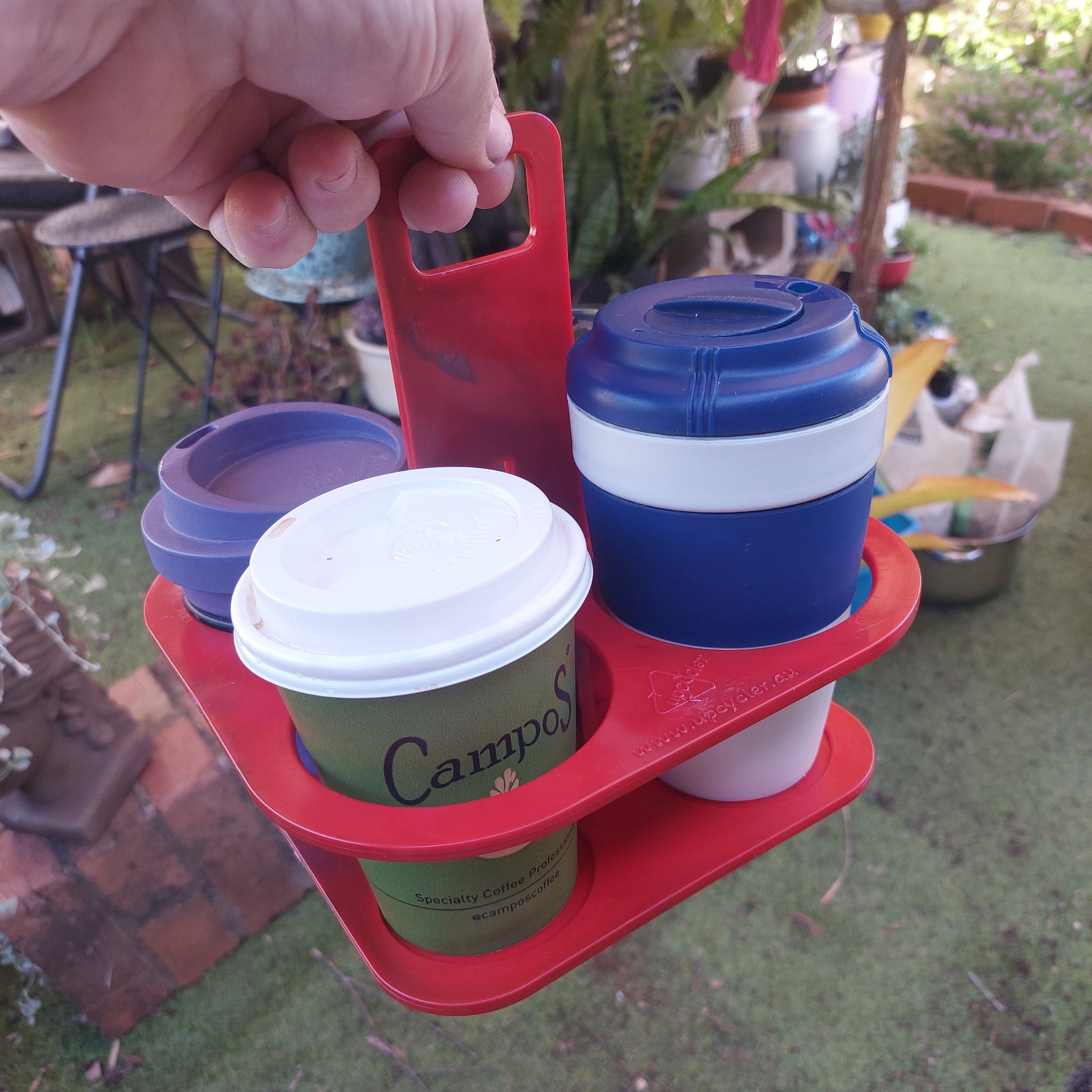 Using the EcoSip Quad reusable 4-cup carrier for a morning takeaway coffee run. Sturdy, washable, and eco-friendly.