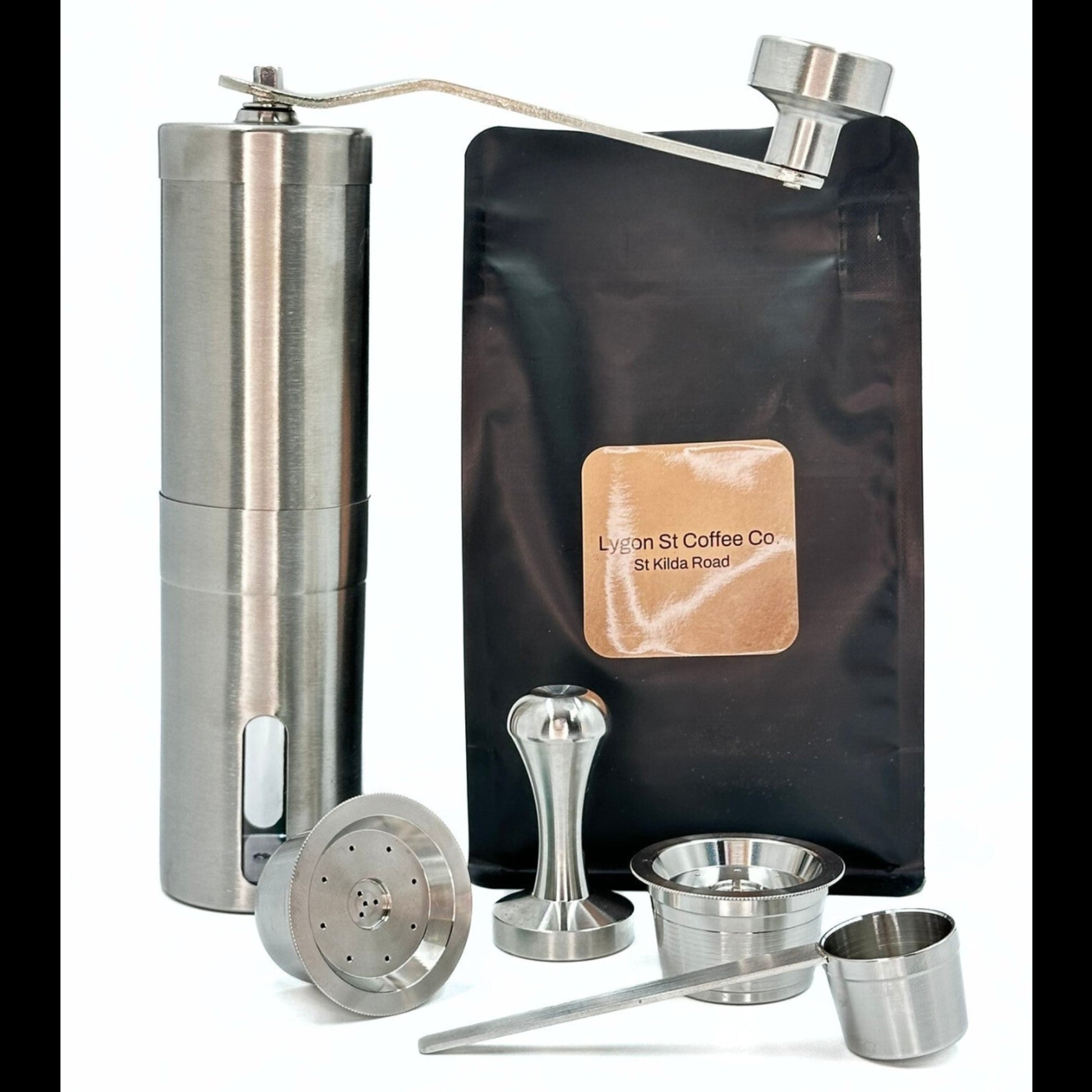 The Pod Star Barista Pack with two stainless steel reusable coffee pods, manual coffee grinder, tamper, coffee pack, scoop.