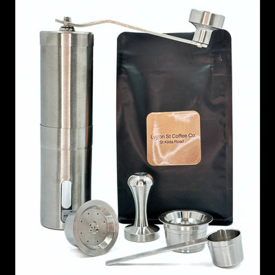 The Pod Star Barista Pack with two stainless steel reusable coffee pods, manual coffee grinder, tamper, coffee pack, scoop.