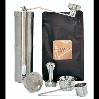 The Pod Star Barista Pack with two stainless steel reusable coffee pods, manual coffee grinder, tamper, coffee pack, scoop.
