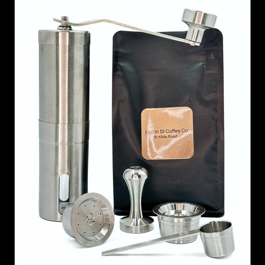 The Pod Star Barista Pack with two stainless steel reusable coffee pods, manual coffee grinder, tamper, coffee pack, scoop.