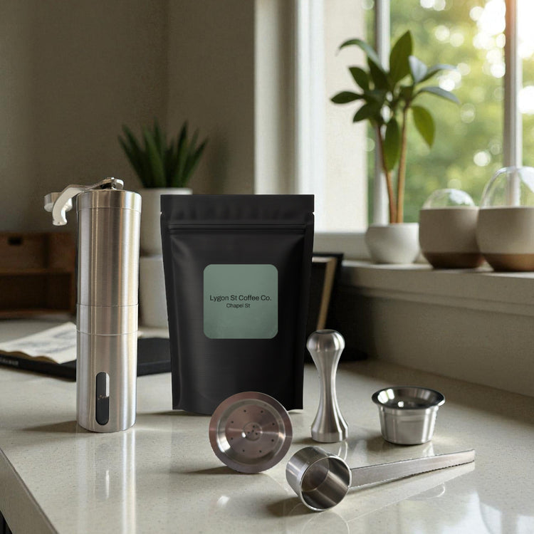 The Pod Star Barista Pack with stainless steel reusable capsules, scoop, tamper and manual coffee grinder with coffee pack.