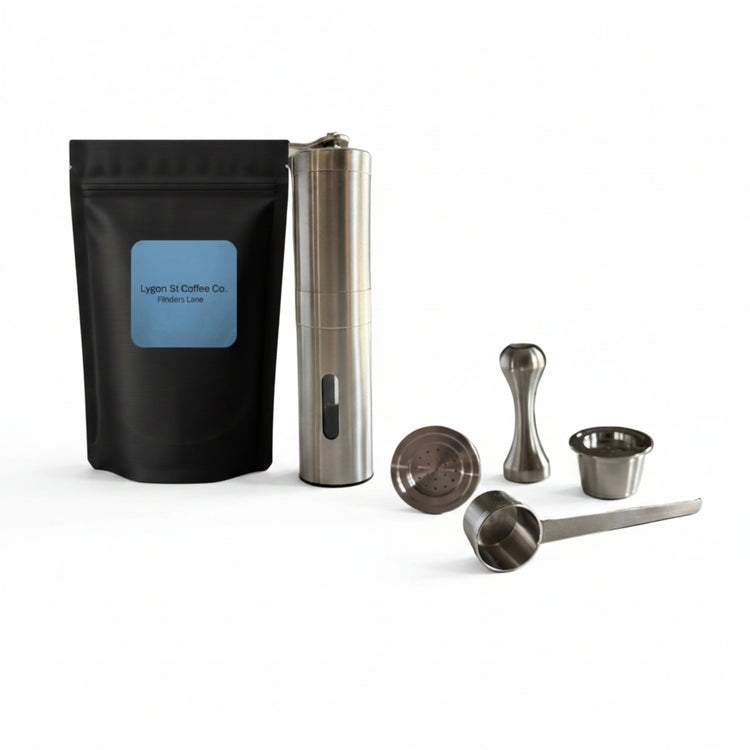 Pod Star barista pack for Espressotoria coffee machines featuring two stainless steel reusable pods, a manual coffee grinder, an espresso tamper, a scoop, and premium coffee beanson a white background.