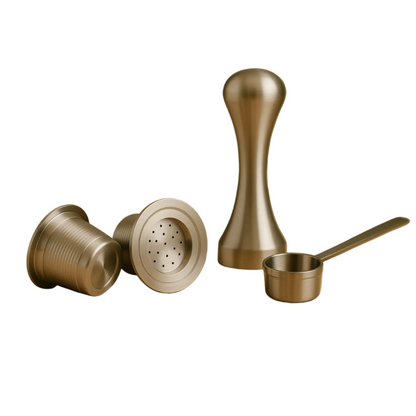 Two refillable stainless steel coffee pods displayed alongside a precision tamper and measuring scoop on a white background.