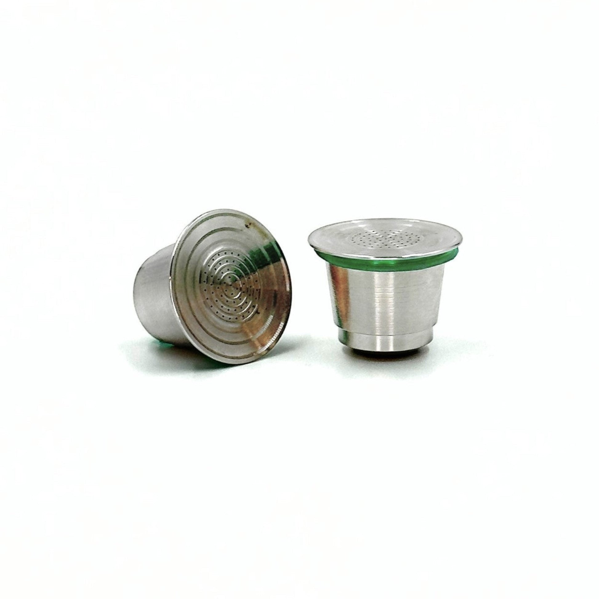 Two refillable stainless steel coffee pods on a white background.