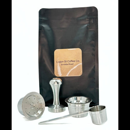 Pod Star starter pack for Aldi K-fee Expressi and Caffitaly  featuring two stainless steel capsules, tamper, scoop, coffee.