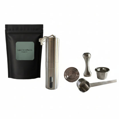 Pod Star ultimate pack for Espressotoria coffee machines featuring four stainless steel reusable capsules, a manual burr grinder, an espresso tamper, a scoop, and coffee beans on a white background.