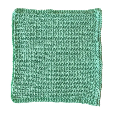 Sea green handmade knitted dishcloth made from absorbent recycled cotton for kitchen and bathroom use.