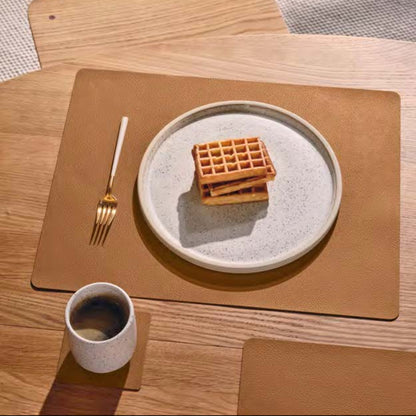 Square recycled leather placemat featuring the signature LIND DNA Serene soft polished finish and subtle suede-like texture in use.