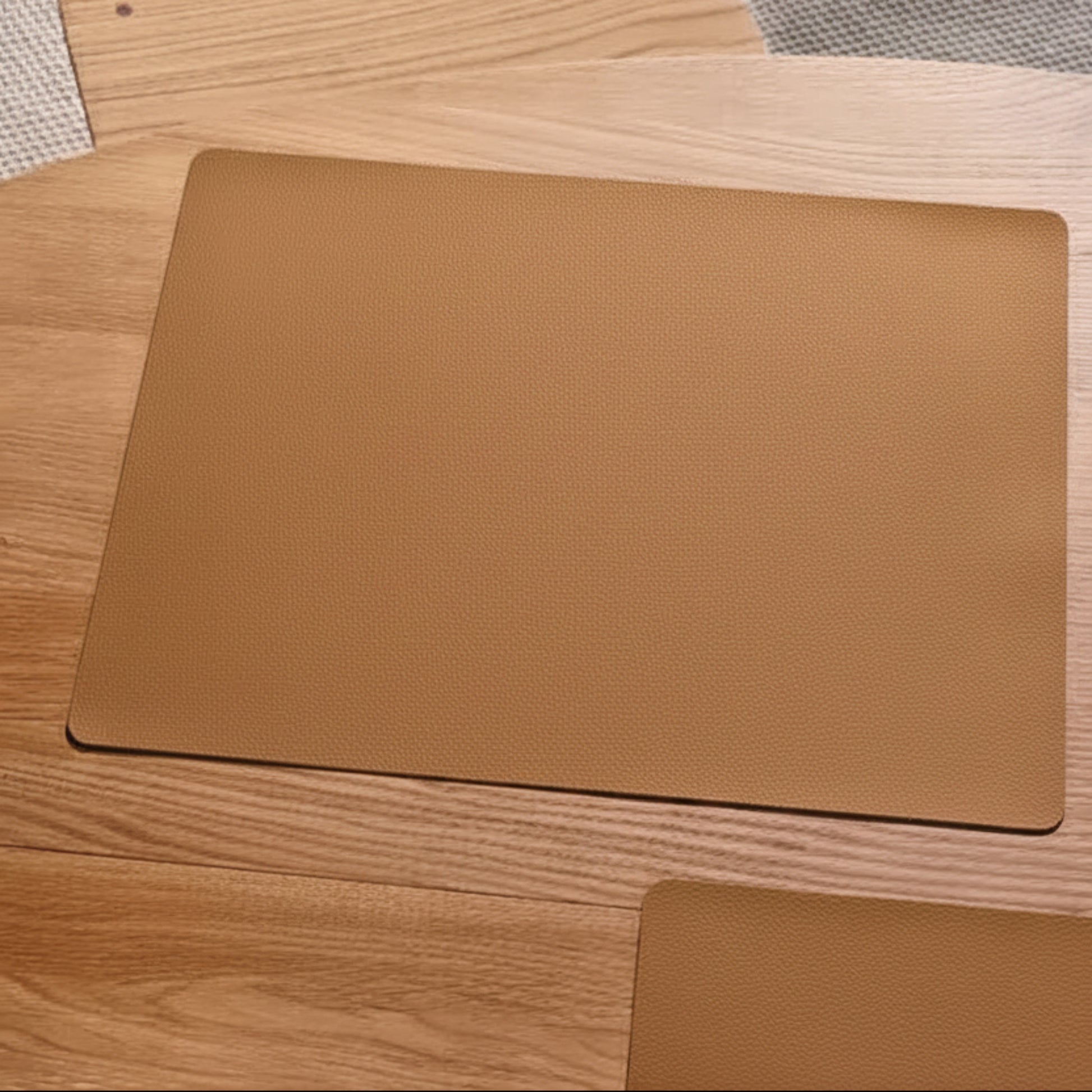 Square recycled leather placemat featuring the signature LIND DNA Serene soft polished finish and subtle suede-like texture on a table top.