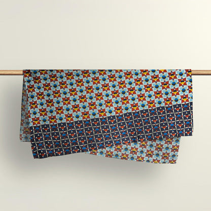 The Shapeshifter abstract pattern fabric wrap draped over a wooden rod to show the premium deadstock material texture.