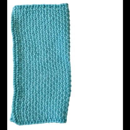 Sky blue handmade knitted dishcloth made from absorbent recycled cotton, folded in half, for kitchen and bathroom use on a white background.