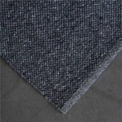 High-resolution close-up corner view showing the flatweave texture of the Zebra Home Clements eco-friendly charcoal grey floor rug.