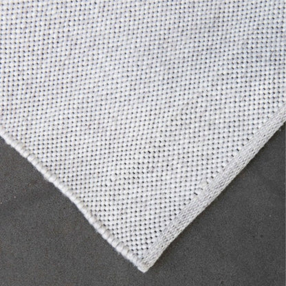 Detailed close-up corner view of the Zebra Home Bates ivory stain-resistant and pet-friendly recycled plastic woven rug texture.