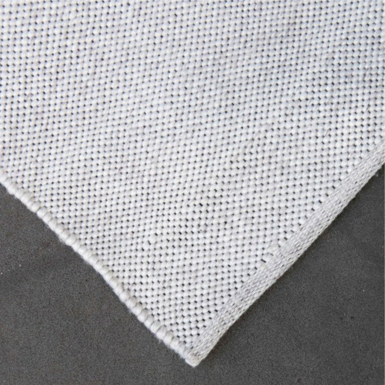 Detailed close-up corner view of the Zebra Home Bates ivory stain-resistant and pet-friendly recycled plastic woven rug texture.