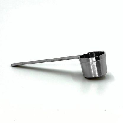 Durable stainless steel coffee measuring scoop spoon for dosing accurate coffee quantities into reusable pod capsules.