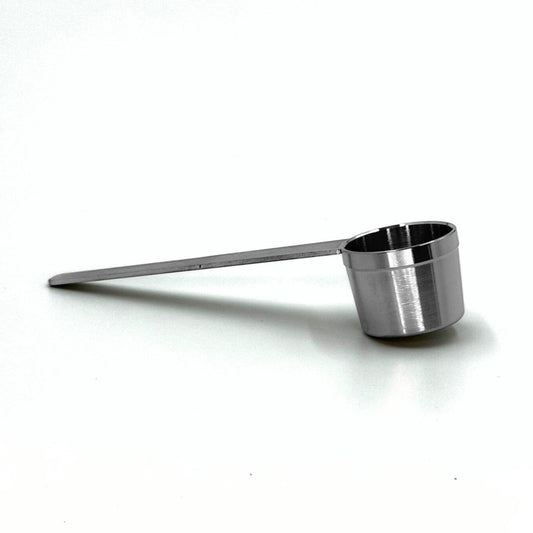 Durable stainless steel coffee measuring scoop spoon for dosing accurate coffee quantities into reusable pod capsules.