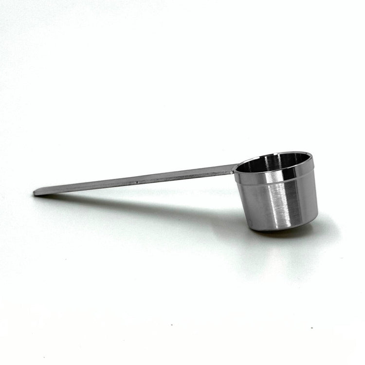Durable stainless steel coffee measuring scoop spoon for dosing accurate coffee quantities into reusable pod capsules.