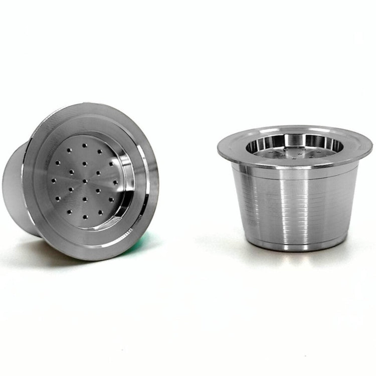 Close-up view of two eco-friendly refillable capsules for Aldi K-fee, Caffitaly or Verismo machines on a white background.