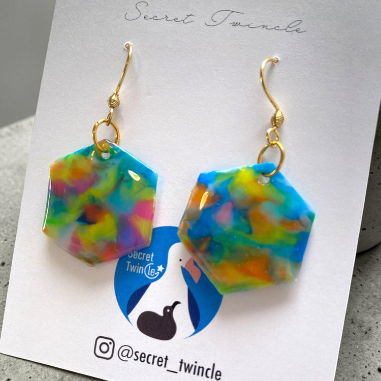 Flat lay studio shot of the blue multi geometric hexagon upcycled earrings, presenting an ideal gift for eco-conscious fashion lovers.