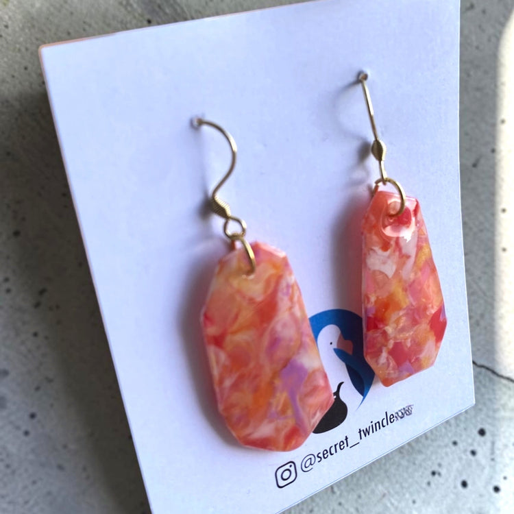 Flat lay photo of the orange red Full Bloom recycled dangles, highlighting a perfect artisan gift for sustainable fashion lovers.