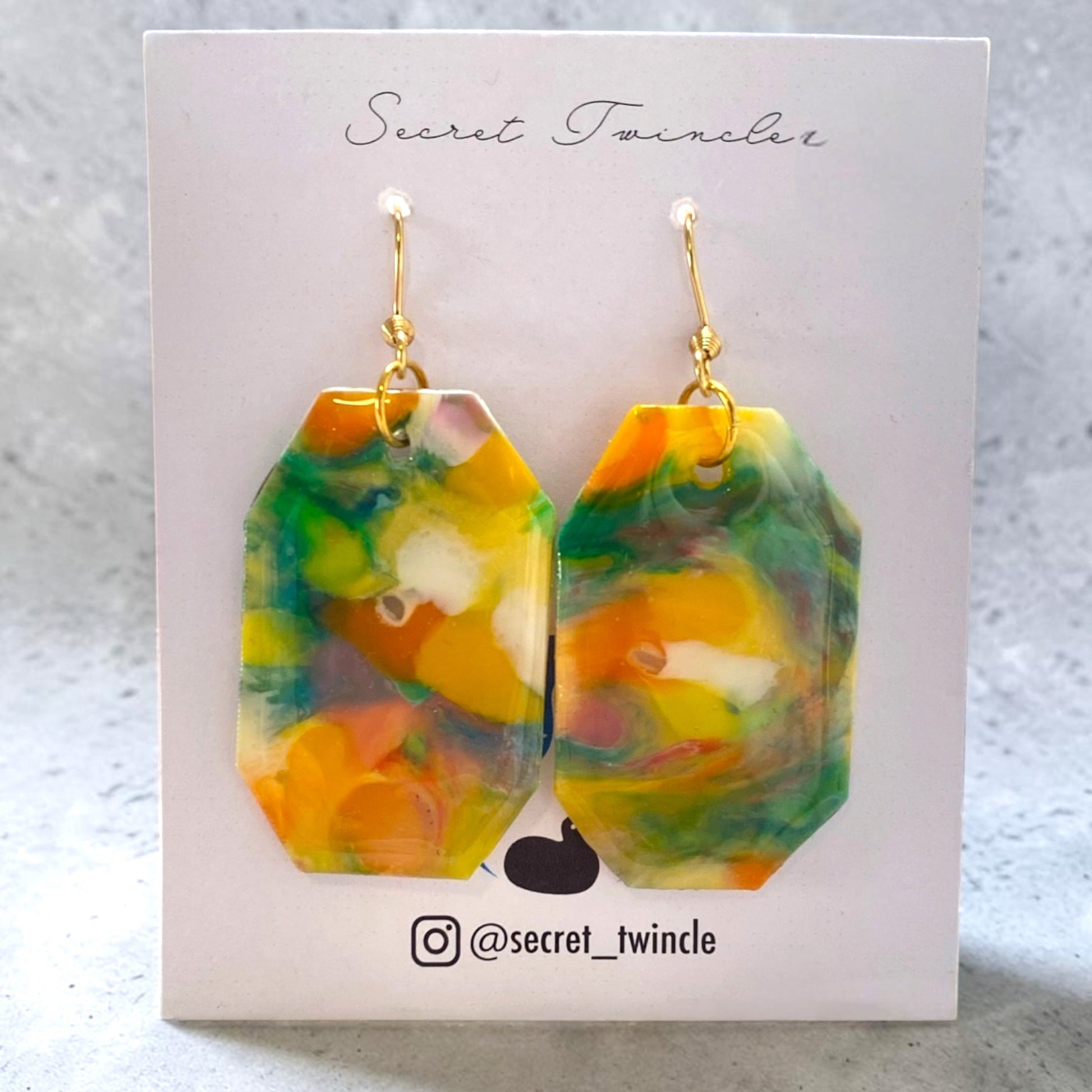 Flat lay photo of the geometric yellow green octagon-shaped upcycled earrings, presenting an ideal gift for sustainable fashion collections.