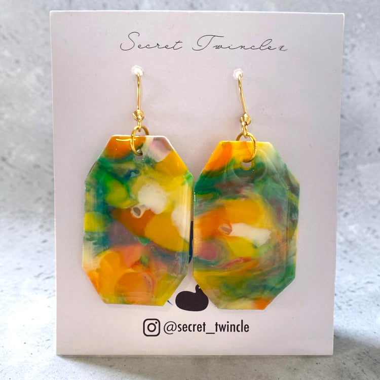 Flat lay photo of the geometric yellow green octagon-shaped upcycled earrings, presenting an ideal gift for sustainable fashion collections.