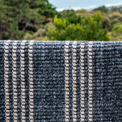 Close-up texture detail of the sustainable woven fabric on a Zebra Home Cornell Lite striped rug.