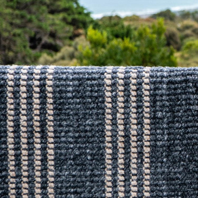 Close-up texture detail of the sustainable woven fabric on a Zebra Home Cornell Lite striped rug.