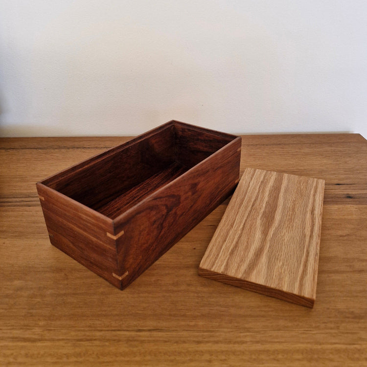 Inside view of a handcrafted timber box with its removable American Oak lid resting alongside the Blackwood base.