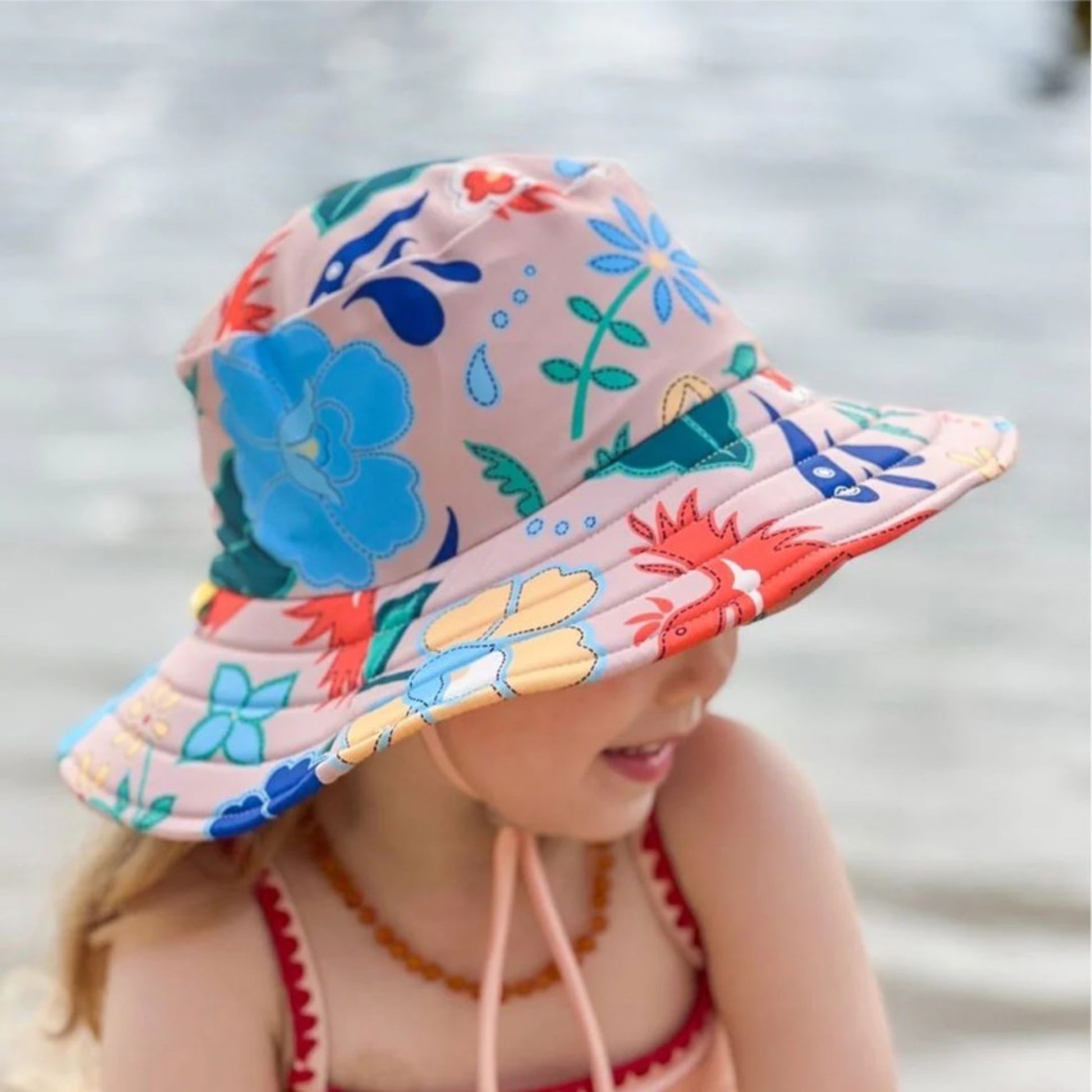Young girl outdoors wearing the Tyoub phoenix vanilla wide brim sun hat for premium UV beach safety in Australia