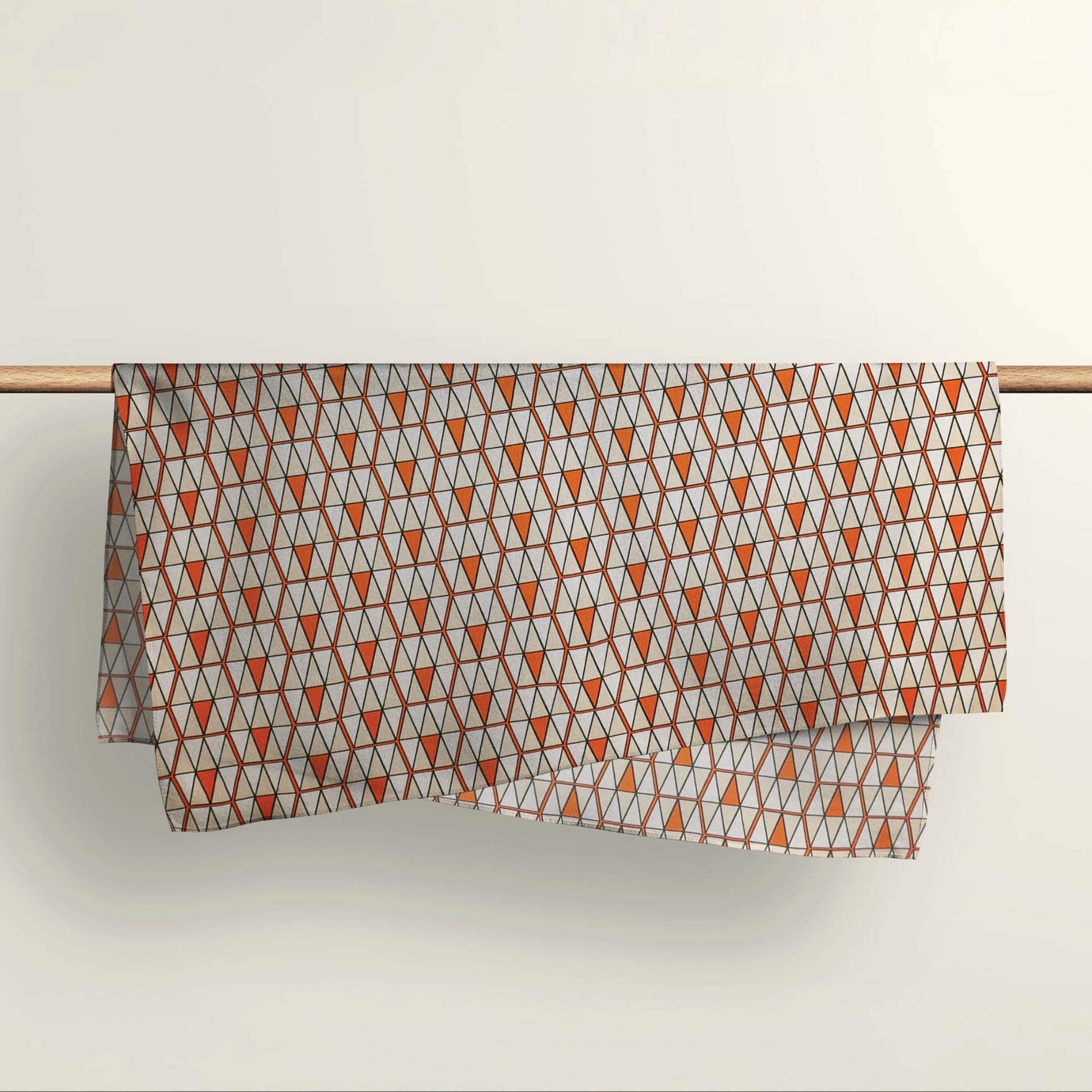 The Triangulation geometric fabric wrap draped over a wooden rod to show the premium deadstock material texture.