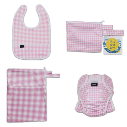 Three-piece baby swim gift set featuring an adjustable nappy, wet bag, and waterproof bib in pink check.