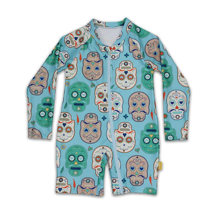Kids long sleeve one piece sunsuit in an aqua blue Skulls Amigo sugar skull pattern with a full zip front closure.