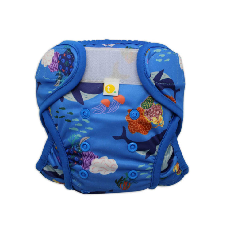 Close-up of adjustable front snaps and leakproof double leg gusset on Whales swim nappy.