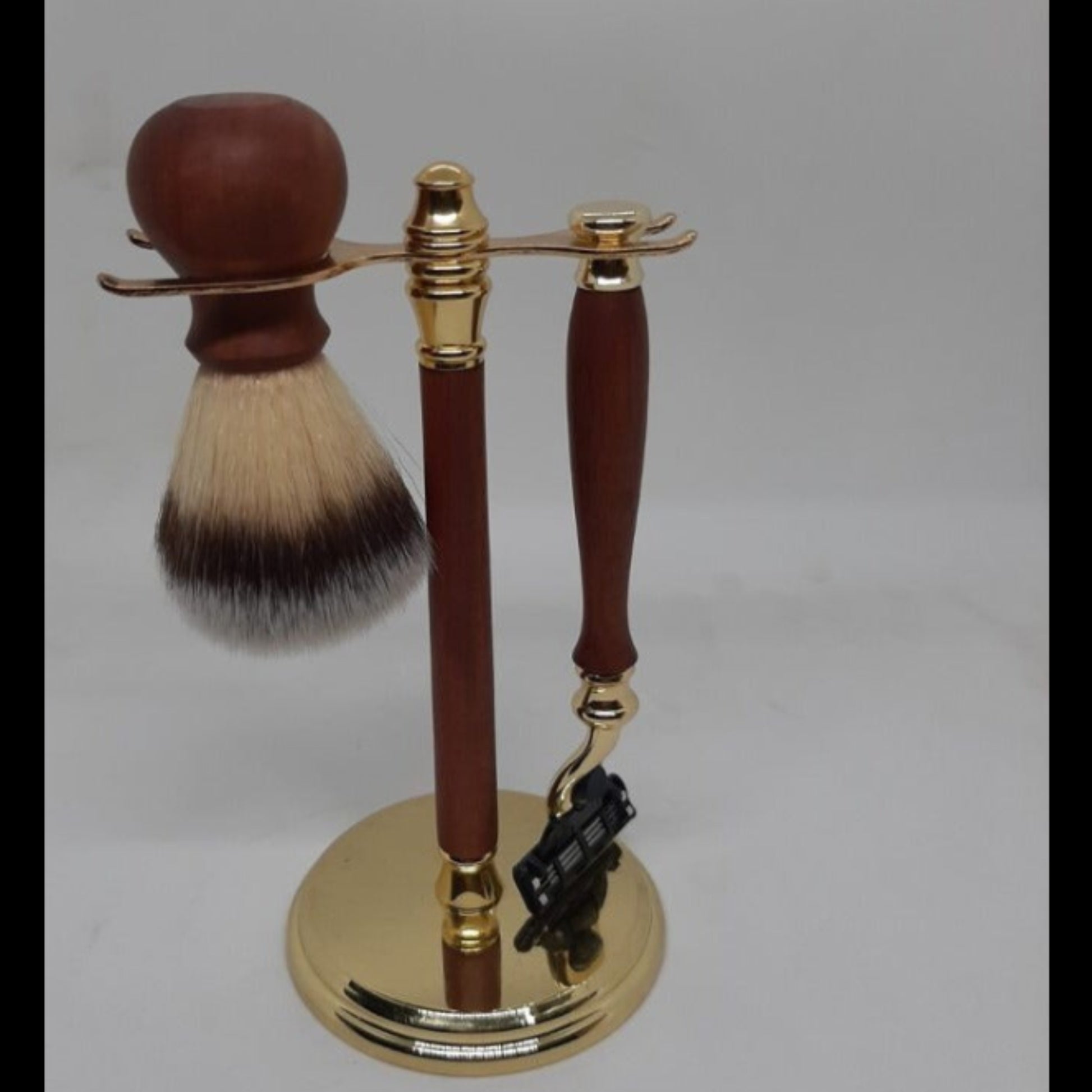 The ultimate 6-piece men's grooming kit showing the recycled timber Gillette Mach III razor, shave brush and display stand in gold.